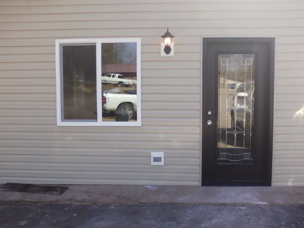 New siding, window and entry door on the side of an addition in Hoquiam