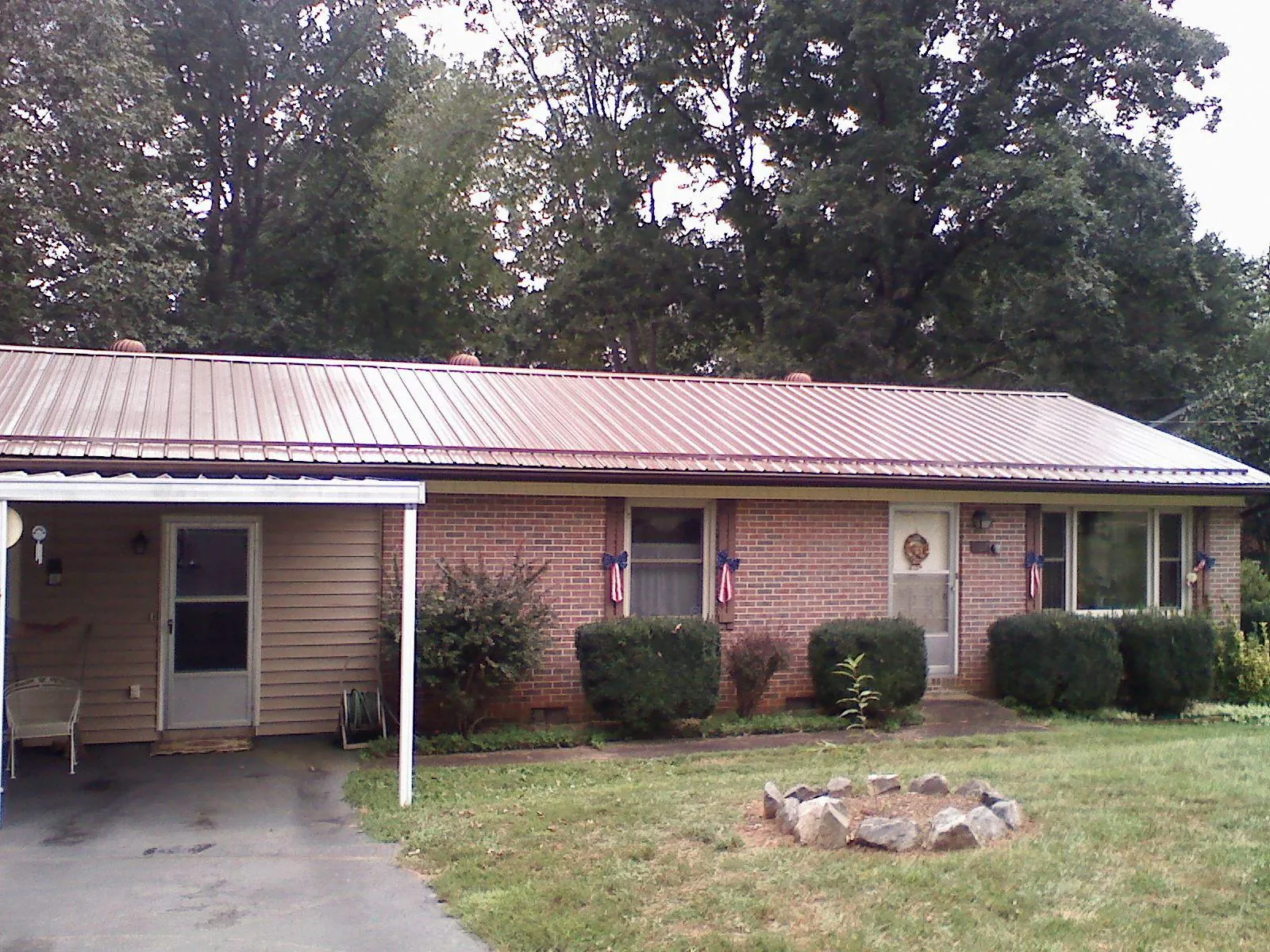 Bronze metal roof and carport on a brick ranch home — Roof Repair work by our crew in Hoquiam